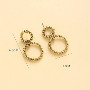 Detail view of gold twisted metal earrings with size measurements of 4.5cm and 2.0cm