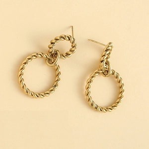Close-up of golden twisted rope texture hoop earrings with elegant interlocking circles
