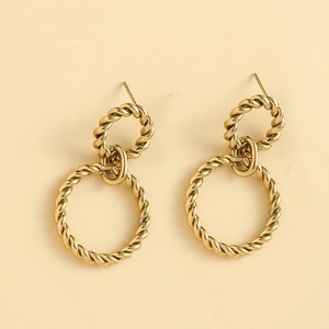 Detailed view of golden twisted rope double hoop earrings with polished vintage texture