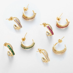 Detail of gold C-shape earrings featuring multi-color baguette-cut cubic zirconia