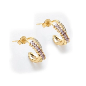Close-up of gold-plated C-shaped earrings with lavender zircons and white crystals