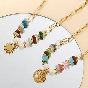 Close-up of bohemian beaded tree of life and sun pendants reflected in a circular mirror