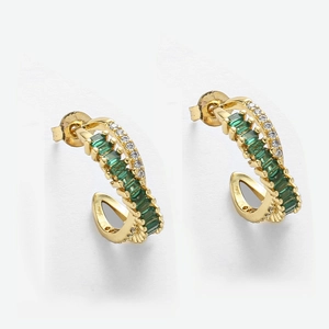 Detailed shot of emerald green zircon C-shaped earrings with gold plating and crystals