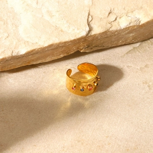 Detailed view of wide gold hammer-textured open ring with five colored zircon stones