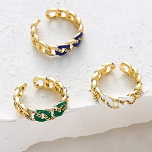 Detail view of colorful enamel chain rings with micro-set zircon on textured stone surface