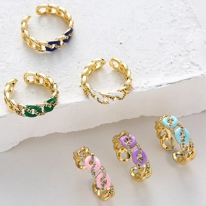 Macro shot of Cuban link rings with colorful enamel finishes and micro-pave zircon crystals