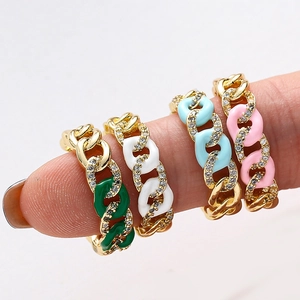 Detail of colorful enamel Cuban chain rings with zircon inlays worn on fingers