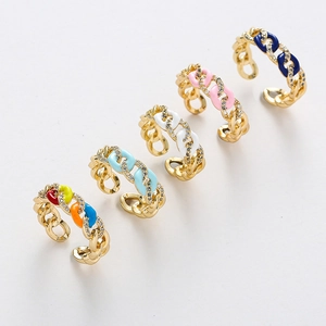 Macro detail of colorful enamel Cuban link rings featuring micro-set zircon accents