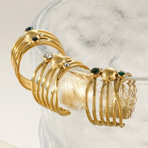 Macro shot of 18k gold plated multi-band rings with colorful gemstones on glass edge