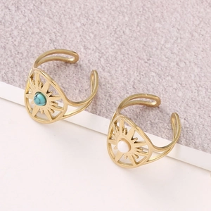 Detailed shot of gold bohemian starburst rings with turquoise and white stones