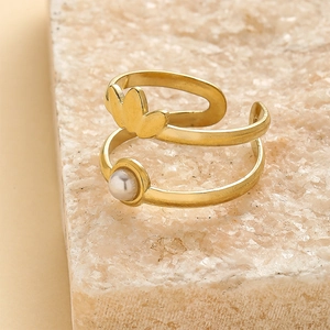 French style double-layer gold crown open ring with a white pearl on stone background