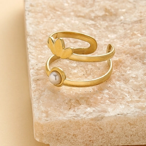Detail view of a gold double-layer crown ring with a pearl on a stone pedestal
