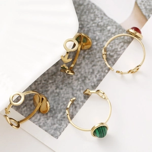 Adjustable gold stainless steel ring set featuring oval malachite and agate gemstones