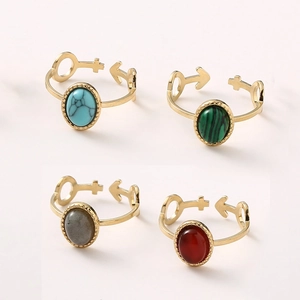 Detail of adjustable gold rings with oval turquoise and malachite stones in a 2x2 grid