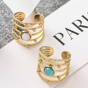 Detail of bohemian gold multi-layer rings with turquoise and marble stone inlays