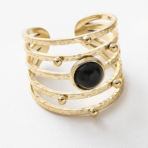 Detailed view of multilayer hammered gold ring with round black stone and metal beads