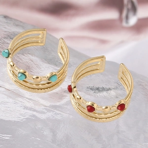 Detail of adjustable gold layered rings with turquoise blue and red bead accents