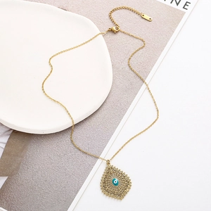 Détail du collier filigrane doré avec pendentif goutte d'eau et perle d'œil maléfique