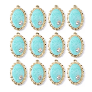 Detail of twelve light blue enamel water drop pendants with gold scalloped edges and rhinestones