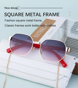 Detail of polygon metal sunglasses with purple gradient lenses and red temples with chain