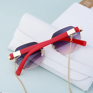 Detail of polygon sunglasses with purple gradient lenses and gold chain accessory