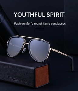 Detail view of double-bridge aviator sunglasses with gold metal bar on a leather case