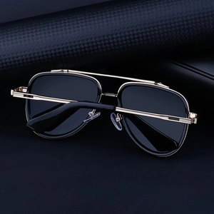 Detailed side view of vintage gold aviator sunglasses with ribbed metal temple hinges