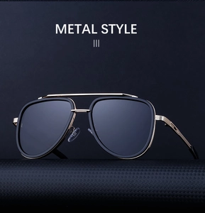 Detail of retro double-bridge sunglasses with gold textured metal temples and black frame