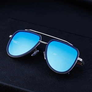 Detail of blue mirrored lenses and silver metal double bridge on retro pilot sunglasses