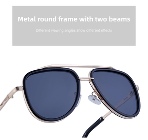 Detail of vintage double bridge sunglasses showing metal engraving and gold composite frame