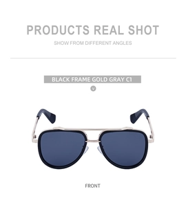 Close-up of vintage double-bridge aviator sunglasses with black and gold metal frames