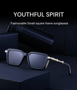 Close-up of matte black square sunglasses with decorative gold metal cutout temples