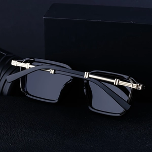 Detailed shot of luxury square sunglasses with black frame and golden metal accents