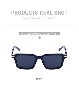 Front view of black square steampunk sunglasses with gold metal hinges and gray lenses
