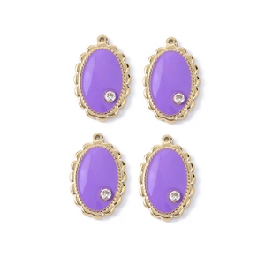 Detail of purple enamel oval pendants with gold scalloped edges and zircon stones