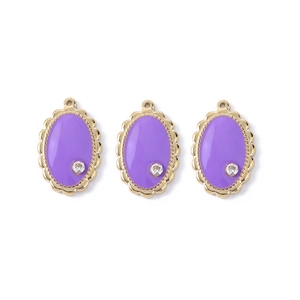Detailed view of three purple enamel flower pendants with gold plating and zircons