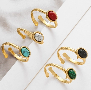 Set of five gold adjustable rings with colorful oval natural stones in a bohemian style