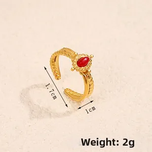 Macro view of adjustable gold ring with red stone showing 1.7cm diameter and 2g weight