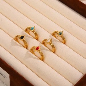Macro view of five vintage gold-plated rings with colorful oval natural stones in a box