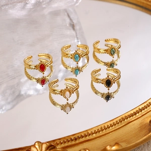 Detailed view of 5-piece retro adjustable gold rings with teardrop gemstone insets