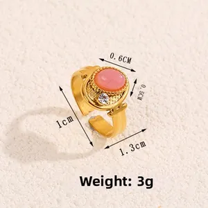Detailed macro view of vintage gold ring with pink opal and size measurements