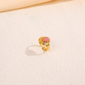 Macro detail of gold vintage double-layer ring featuring a pink oval stone and zircon