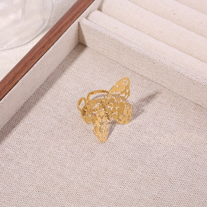 Gold hollow butterfly ring in titanium steel with classic hammered texture and openwork wing