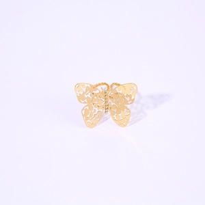 Detailed view of an open-wing hollow butterfly ring featuring golden hammered texture design