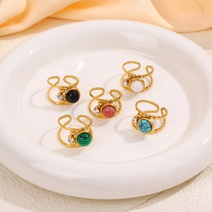 Detail of five gold layered rings with colorful natural stones and small diamonds