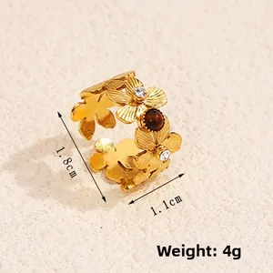 Macro detail of 18k gold plated flower ring with crystals and brown tiger eye stone
