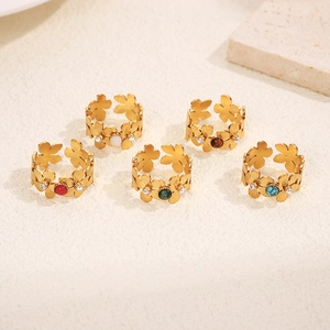 Detail of five 18k gold plated floral rings with colorful gemstones and zircon accents