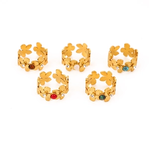 Detail view of five geometric flower open rings with colorful stones in 18k gold plating