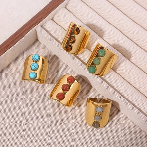 Three-stone wide open ring in polished titanium steel with various natural stones