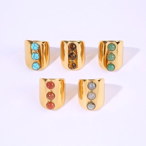 Set of five wide gold titanium rings featuring three vertically set colorful gemstones